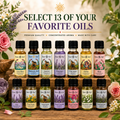 A promotional display of 13 small essential oil bottles from Sun's Eye arranged on a wooden stand, with large text reading 'SELECT 13 OF YOUR FAVORITE OILS' and floral decorations around the bottles.