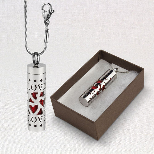 Silver cylindrical pendant with heart designs and 'LOVE' text, displayed with a brown box on a light gray background. Sun's Eye Scentsium