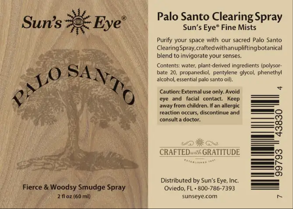 The back of a Sun's Eye Palo Santo Clearing Spray bottle, showing the product name, ingredients, warnings, and barcode on a light beige background with a wood-grain texture.