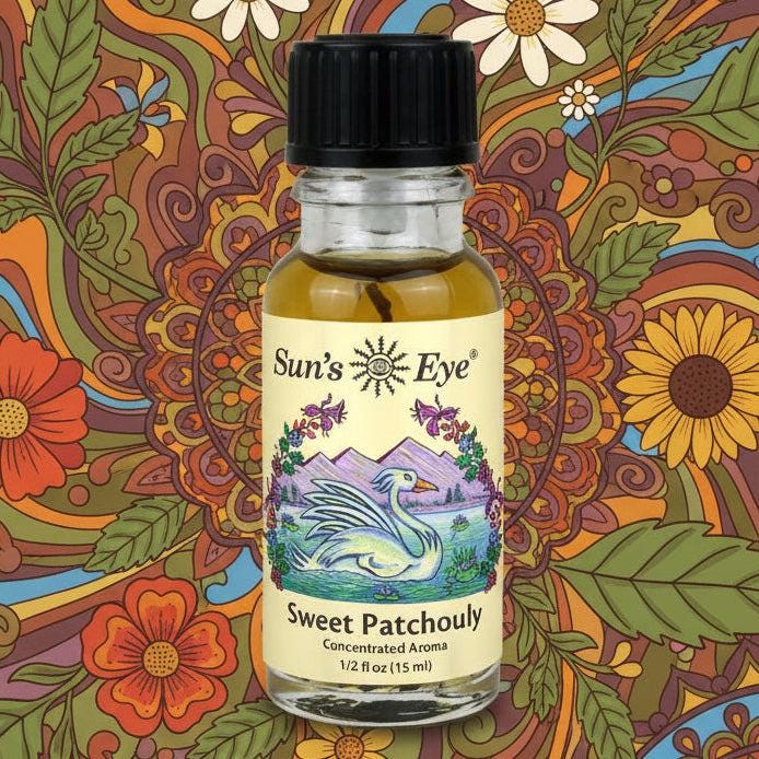 Bottle of Sun's Eye Sweet Patchouly with a colorful floral and nature-themed background