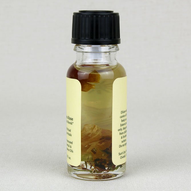 Small glass bottle with a black cap and yellow label on a light gray background