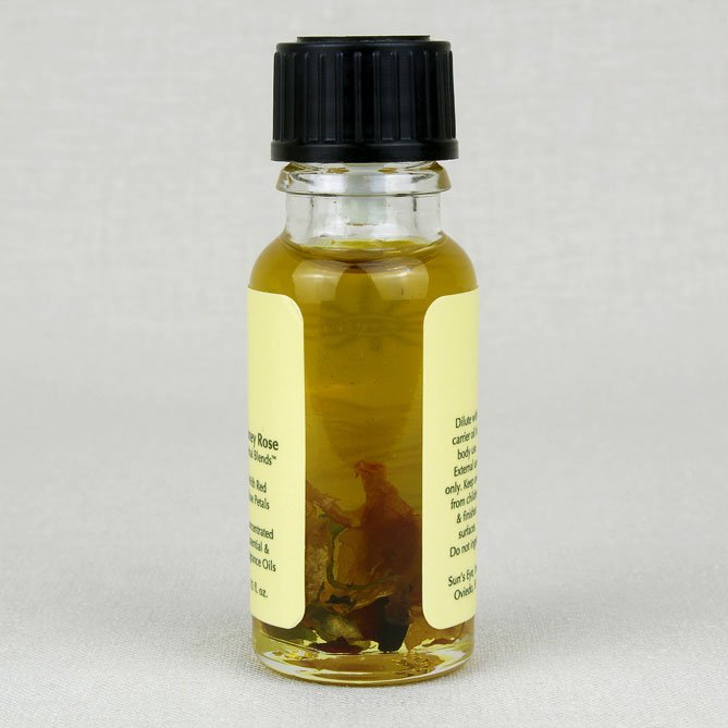 Small glass bottle with a black cap containing a yellowish liquid on a light gray background