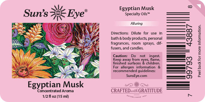 Pink Sun's Eye Egyptian Musk Specialty Oils label showing product information, a colorful floral illustration, directions, warning, and barcode on a pink background.