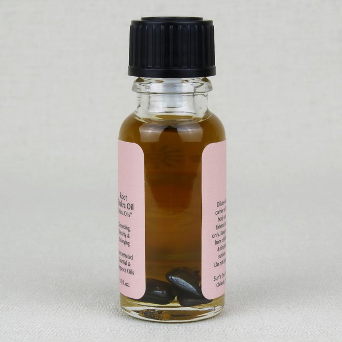 Small glass bottle with a black cap and pink label on a light gray background
