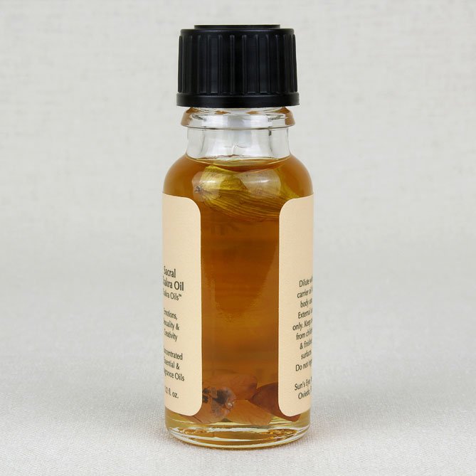 Small glass bottle with black cap and label on a light gray background