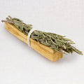 Bundled rosemary and Palo Santo wood with a white background