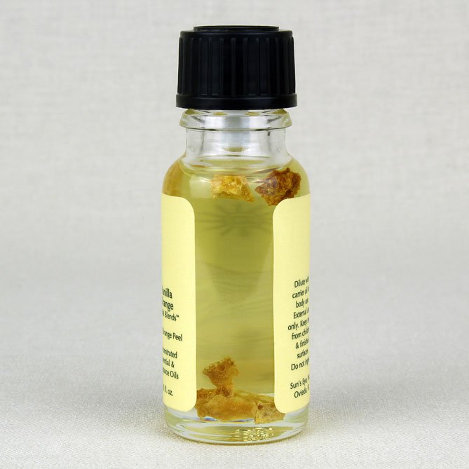 Small glass bottle with a black cap containing a yellow liquid on a light gray background