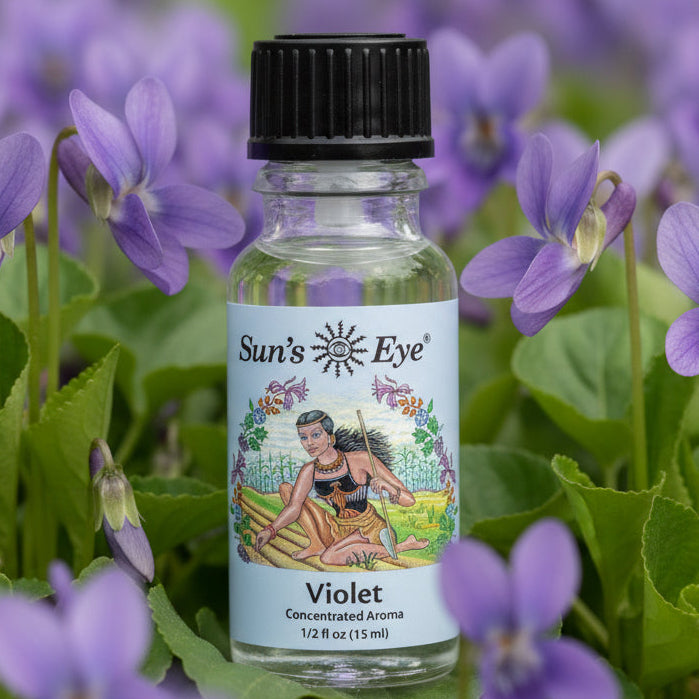 Bottle of Sun's Eye Violet concentrated aroma on a background of violets